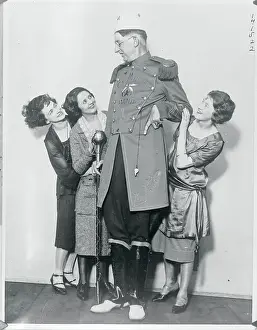 Young Women Embracing Very Tall Gentleman