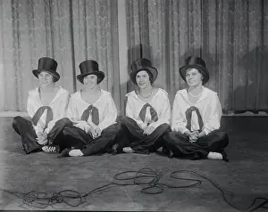 Young Women Posing in Top Hats at Charity Function