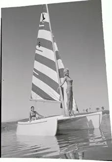 Young Women Posing on Sailboat in Waters