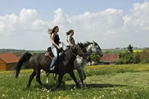 Perissodactyla Gallery: Two young women riding on horseback, Bavaria, Germany, Europe