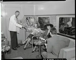 Young Women Being Served in Train Lounge Car