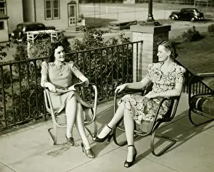 Quality Time Prints: Two young women sitting on terrace, talking, (B&W)