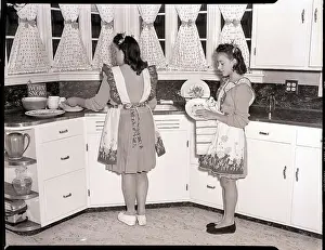 Apron Prints: Two Young Women Washing Dishes