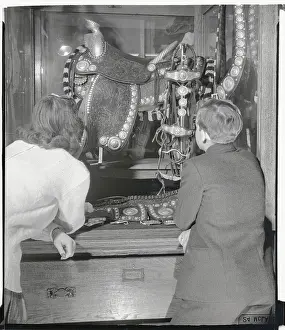 Two Youngsters Admiring Ornate Saddle