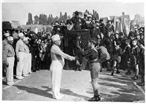 Receiving Prints: Youth Receives Rifle as Mussolini Looks