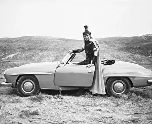 Prints of Actor Yul Brynner, in costume for the movie Solomon and Sheba takes a break and goes for a spin in his Mercedes-Benz 190 SL Vintage Car Collection Prints: Yul Brynner in Costume with His Mercedes